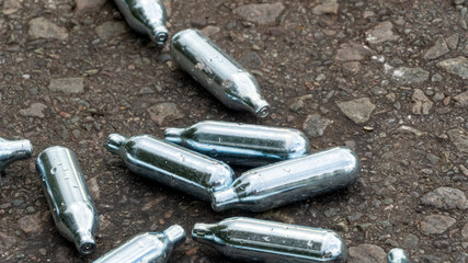 Nitrous Oxide used gas canisters discarded on the roadside