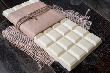 White chocolate tablet on rustic background