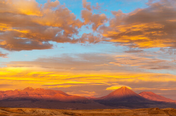 A majestic sunset landscape in the Atacama desert between the Moon and Death Valley with the famous Licancabur volcano, Chile.