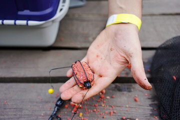 
fisherman string bait on a fishing rod. Fishing concept

