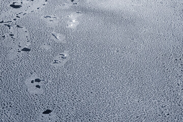 Water drops on the new asphalt road surface.