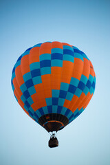 Big balloon flies against the sky
