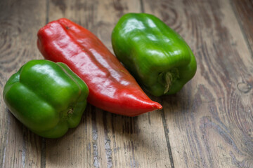 Green red pepper on a wooden surface, concept on the topic of healthy vegetables on the table, Shallow depth of field, Selective focus