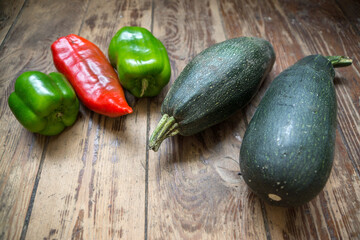 Black pepper and zucchini on a wooden surface. healthy vegetables, vegetable diet, Selective focus, shallow depth of field