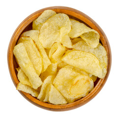Salted potato chips with peel, also crisps, in wooden bowl. Thin slices of potato, deep fried in oil until crunchy. Served as snack, side dish or appetizer. Close-up from above over white, food photo.