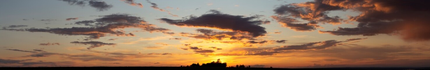 Fototapeta premium The evening sunset. Panorama. Purple clouds. Tragic gloomy sky.