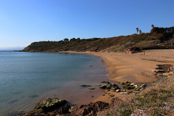 A long, fine-sanded and sun-drenched beach in Southern Italy.
