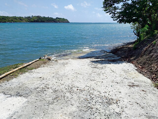 Perspective of path ending into the turquoise waters of the Caribbean Sea under tropical blue sky....