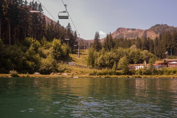 chairlift in the mountains over a lake