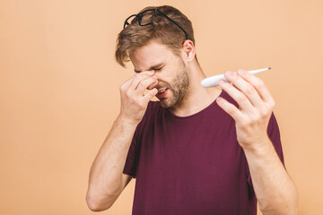 I feel bad! Man caught cold , flu, running nose. Healthcare and medical concept isolated over beige...