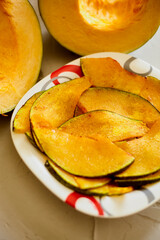 A plate of baked pumpkin pieces on the plate. Sweet quick snack