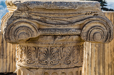 Close-up of the remains of the column with its Ionic capital with scrolls and flourishes on the Acropolis of Athens. Athens. Greece. - 374395298