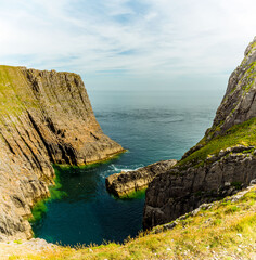 Vertical rock strata at Lydstep Cavens, Wales in early summer