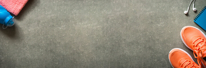 Fitness equipment at stone background top view.