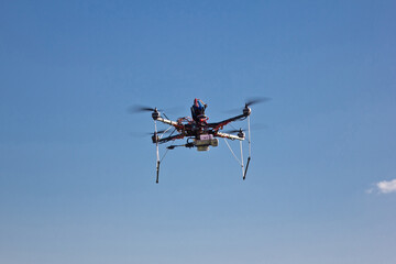 Flying handmade drone on blue sky background