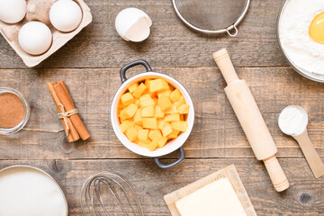 Top view raw ingredients for cooking pumpkin pie on wooden background. Bakery background.