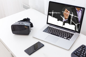 young manual worker displaying laptop over white background