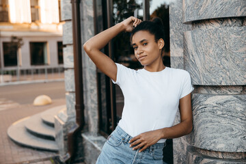 Young cool African skin model poses in the street.