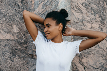 Young cool African skin model poses in the street.