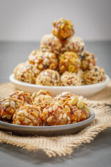 energy protein balls made with dry apricots, raisins, dates, walnuts, sunflower seeds, pumpkin seeds, sesame