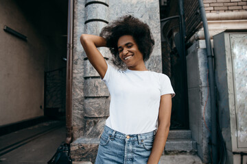 Young cool African skin model poses in the street.