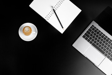 business layout, keyboard buttons and laptop fragments in black and silver, Notepad with white paper, pencil and coffee Cup, background