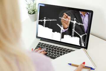 young manual worker displaying laptop over white background