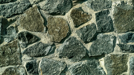 Gray stone wall. Stone masonry