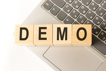 Word demo. Wooden cubes with letters isolated on a laptop keyboard. Business Concept image.