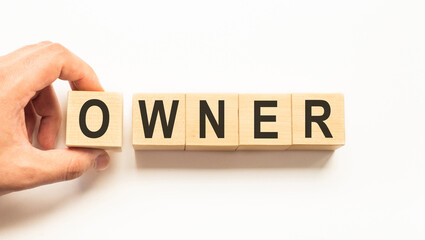 Word owner. Wooden small cubes with letters isolated on white background with copy space available.Business Concept image.