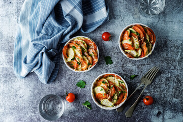 Zucchini tomato casserole with pepper and parsley in white bowl
