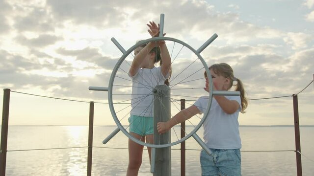 Children at the helm of the ship. Happy childhood.