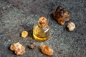 A bottle of frankincense essential oil with frankincense resin