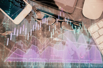 Multi exposure of forex graph hologram over desktop with phone. Top view. Mobile trade platform concept.