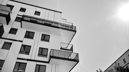 Detail of modern residential flat apartment building exterior. Fragment of new luxury house and home complex. Black and white.