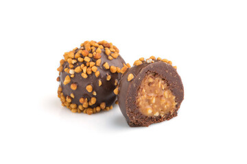 Chocolate caramel ball candies with almonds isolated on white background. Side view.