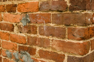 Close up of rough faced bricks with repeating pattern and varying colors, red to black and white. Lines and design, works as a backgrond., stabds for solidness, commitment, stability., lasting,.