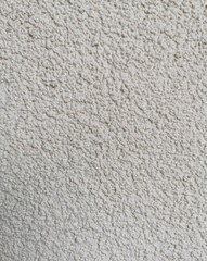 Detail of the facade of the house, wall plastered and painted in gray