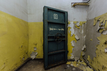 Opened heavy steel armored hermetic door in the Soviet bomb shelter