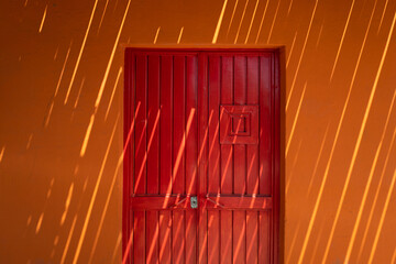 red door covered by shadows