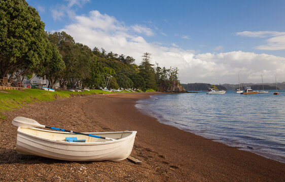 A dinghy rests on the shore in Russell, a seaside town in the Bay of Islands on the North Island of New Zealand
