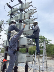 Maintenance workers are fixing and maintaining C-bank units.
