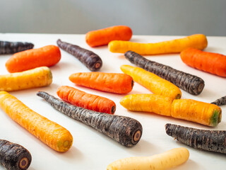 Variety of Purple, Yellow and Orange Carrots on a White Background