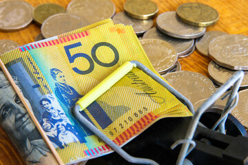 Australian fifty dollars caught in a mouse trap.