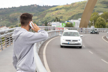 man with mobile phone on the road calling assistance