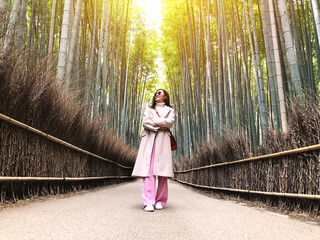  Asian woman traveling at Bamboo Forest in Kyoto, Japan.