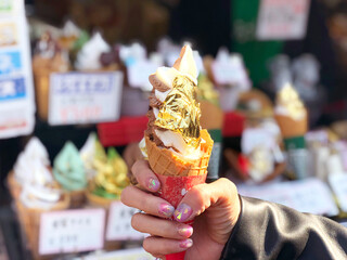Ice cream cone covered with real gold leaf a famous street food in Japan