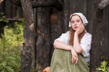 Portrait of Redhaired Girl in Rustic Style Resting in Countryside. Example of Simple Village Lifestyle