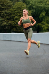 Caucasian Female Runner During Her Regular Training Exercises Outdoor.