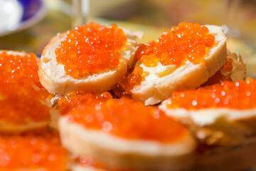 Closeup Shoot of Sliced Baguettes With Butter And red Salmon Caviar on Plate